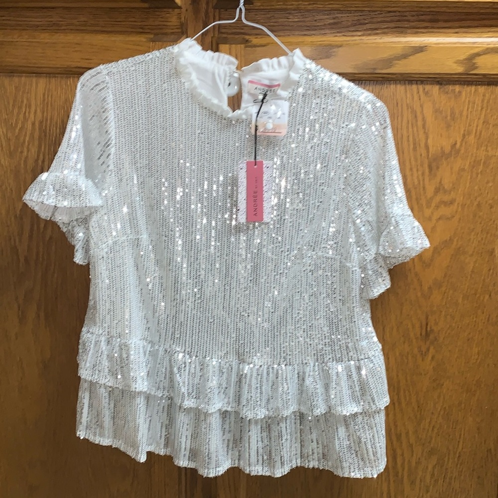 Sparkle with this White Andree top with silver dazzles short   sleeve sz M